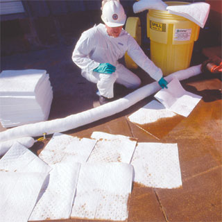 photo of a technician cleaning up factactory floor spill